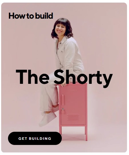 smiling woman in white overall sitting on a pink closet